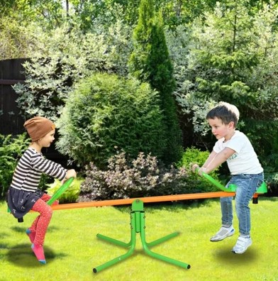 Parent supervising two children riding a backyard teeter totter safely